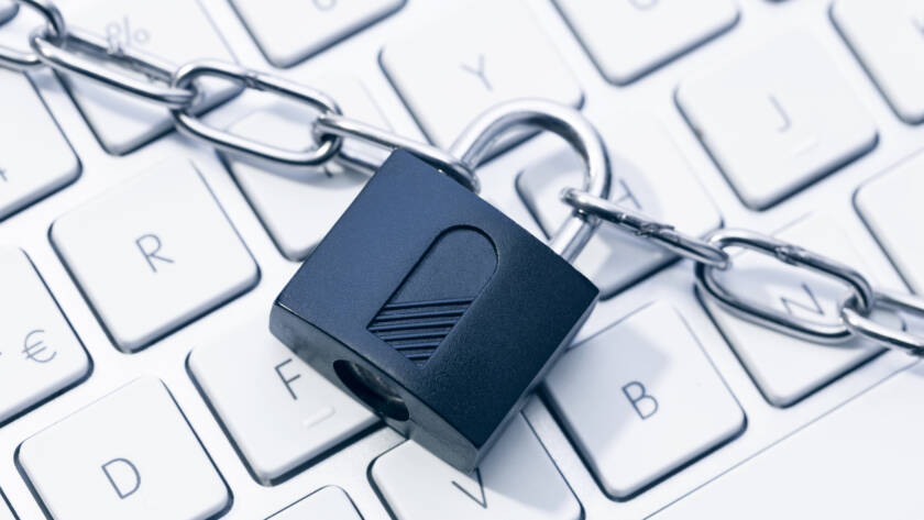 Picture of a keyboard with a lock over the top of it.